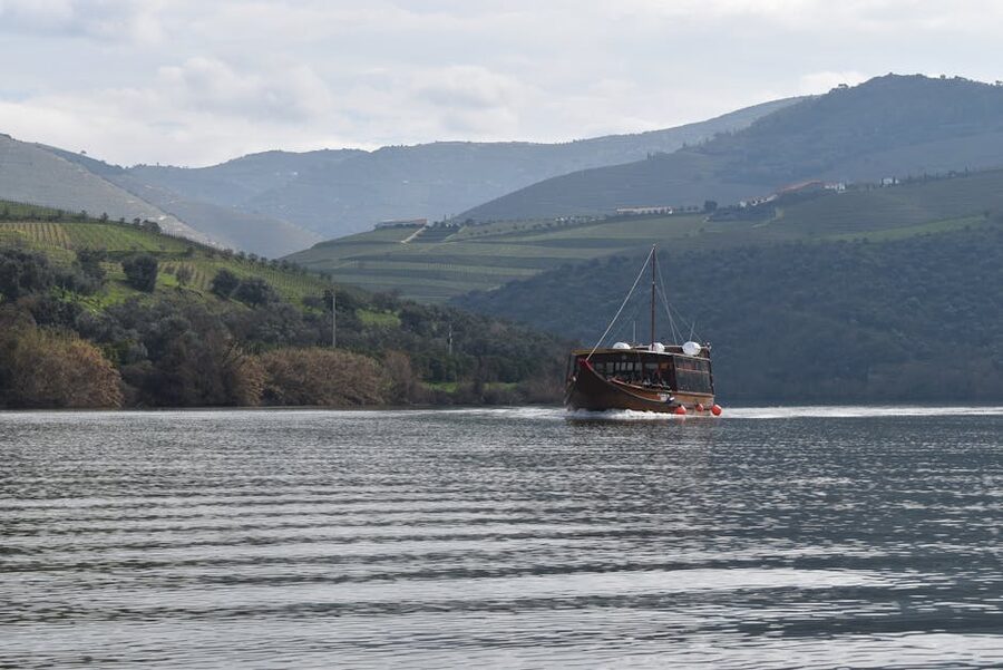 Douro riverboat with vineyard hills