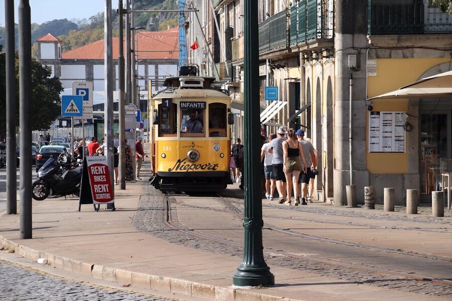 Yellow Porto tram on cobblestone street