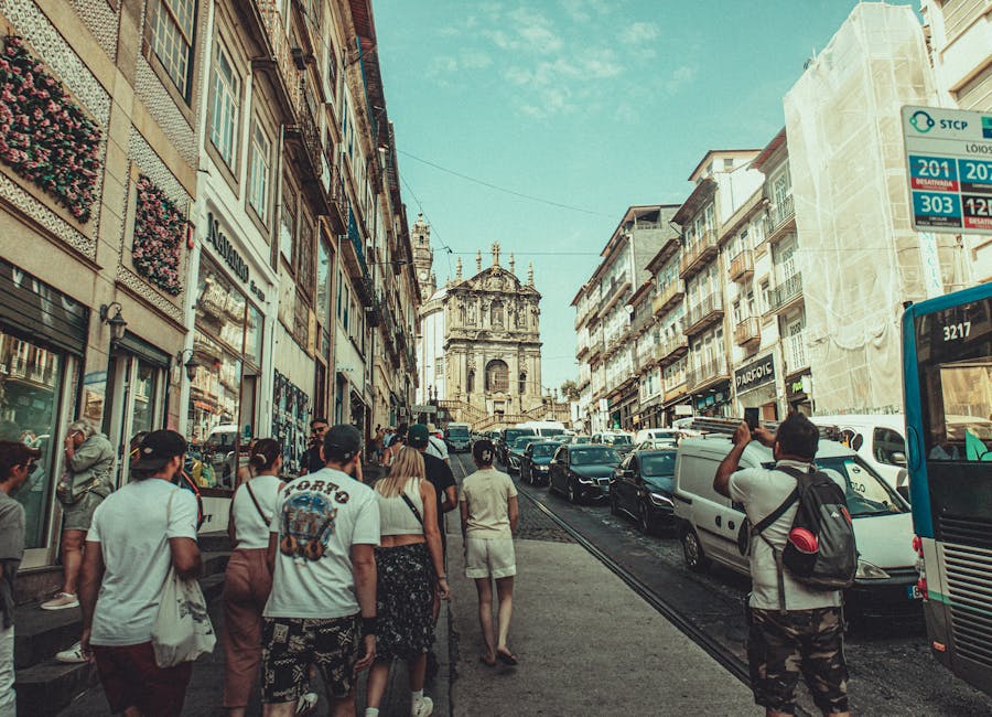 Tourists walking historic Porto street with classic architecture