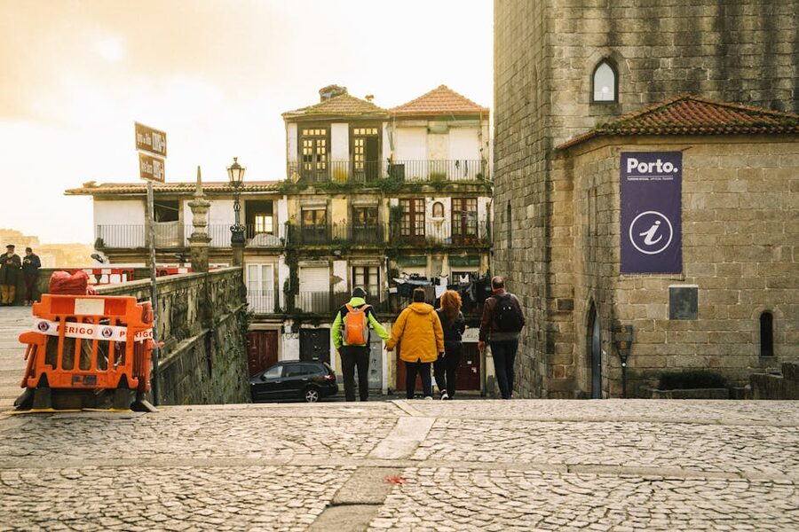 Walkers descending a steep cobblestone street in Porto