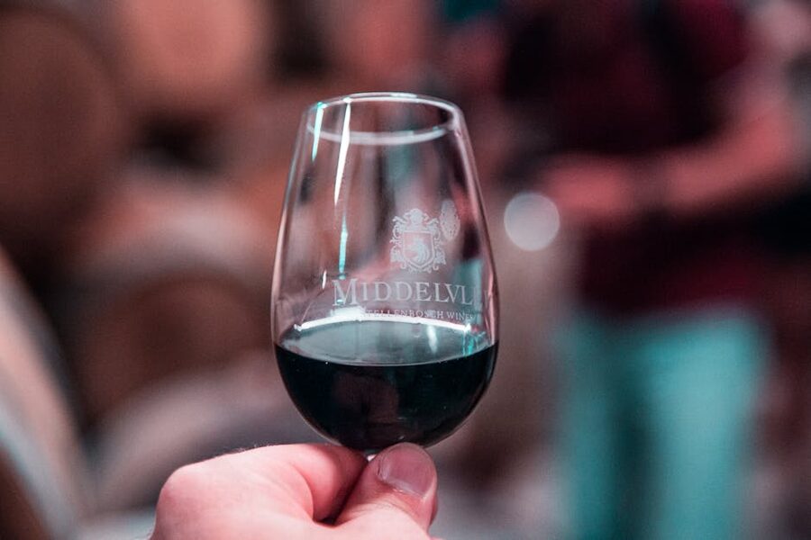 Hand holding a glass of port wine before fado show