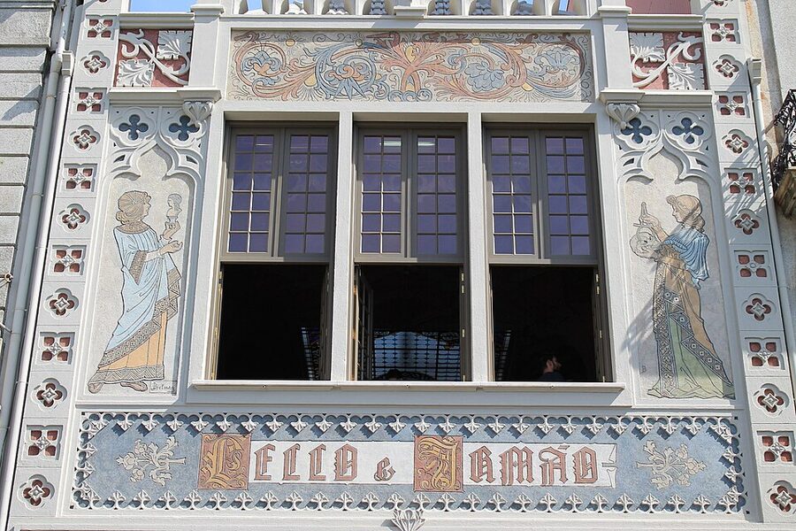 Stained glass skylight at Livraria Lello with Decus in Labore motto