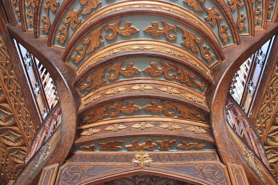 Detail of curved red staircase at Livraria Lello