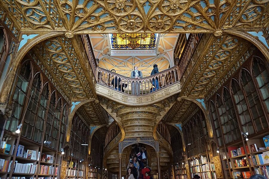 Livraria Lello staircase skylight and bookcases wide view