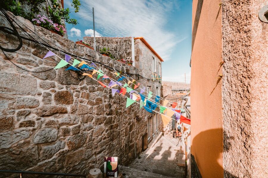 Narrow Porto alley with colorful flags and flagstone steps