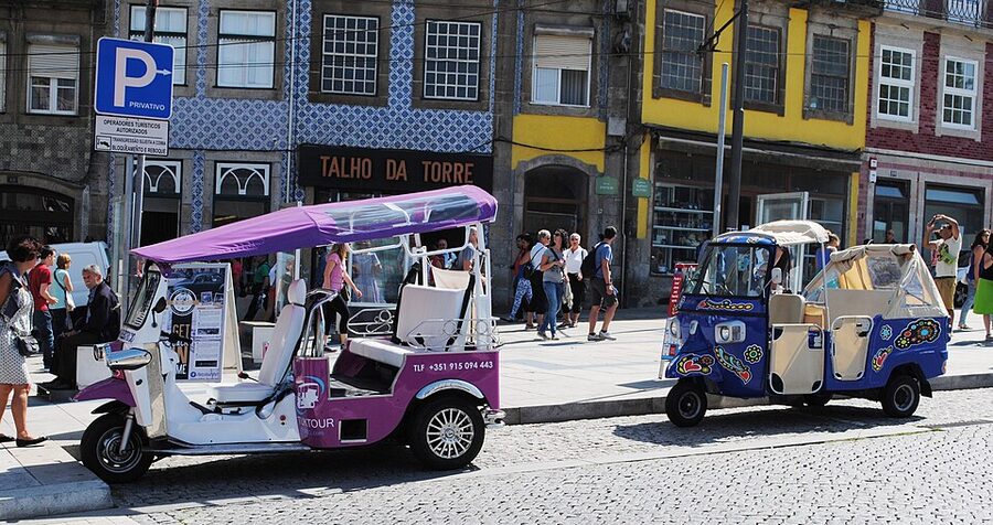 Purple Piaggio Ape tuk-tuks parked in central Porto