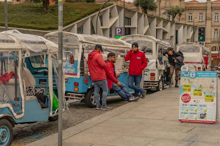 Tourists at a Porto tuk-tuk station ready to start a tour