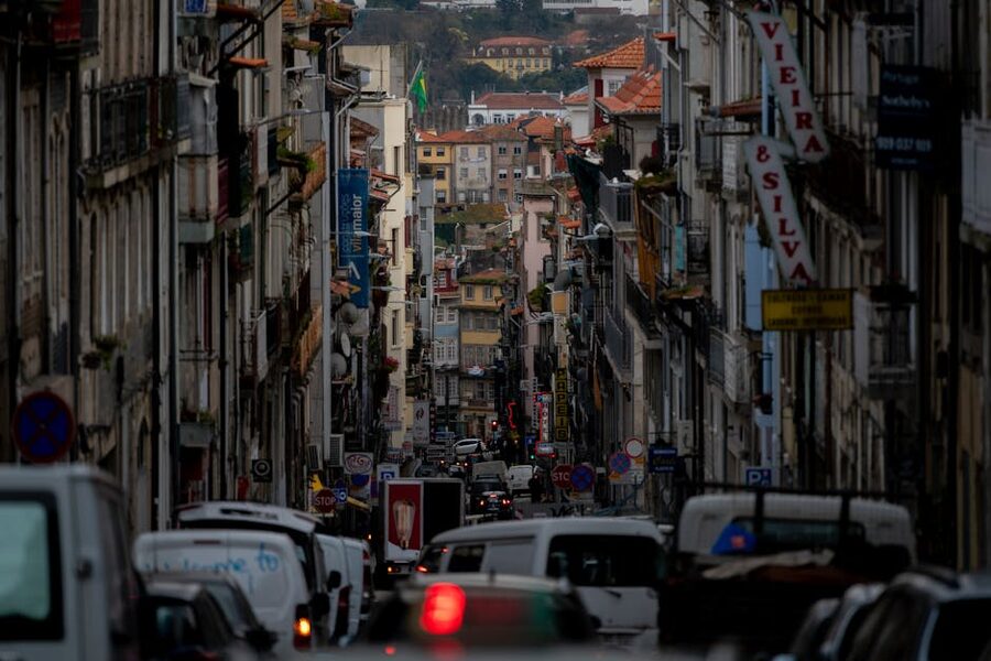 Porto narrow street with tuk-tuk traffic threading through historic buildings