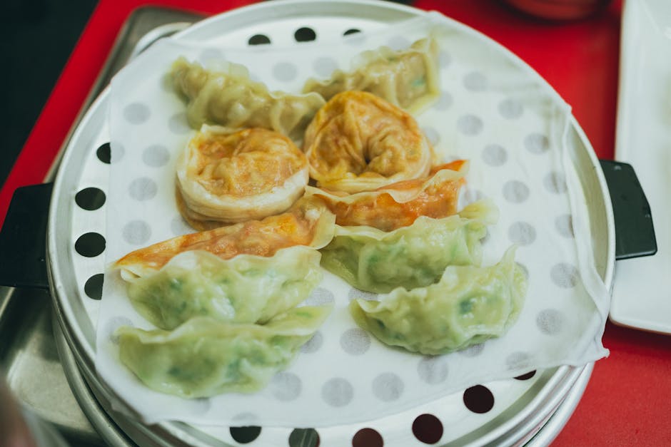 Steamed mandu dumplings fresh from a bamboo steamer basket