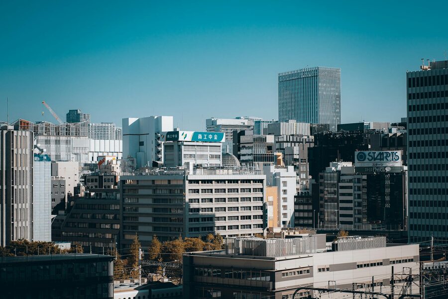 Aerial daytime view of Tokyo skyscrapers and modern city buildings stretching to the horizon