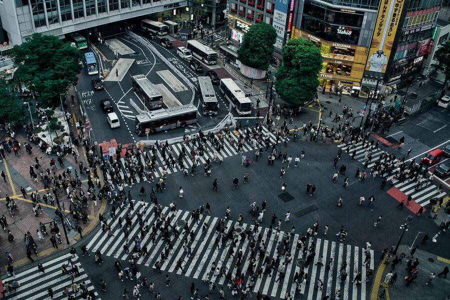 Aerial overhead view of Shibuya scramble crossing with pedestrians and vehicles in Tokyo