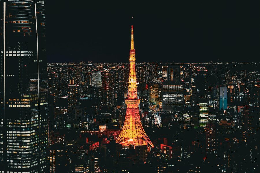 Tokyo Tower lit up in orange against the nighttime city skyline