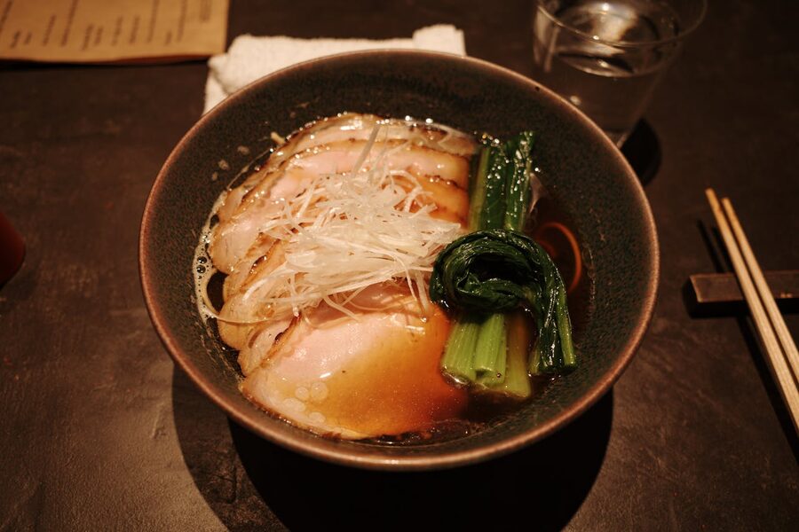 Japanese ramen with rich broth, pork slices, and fresh greens