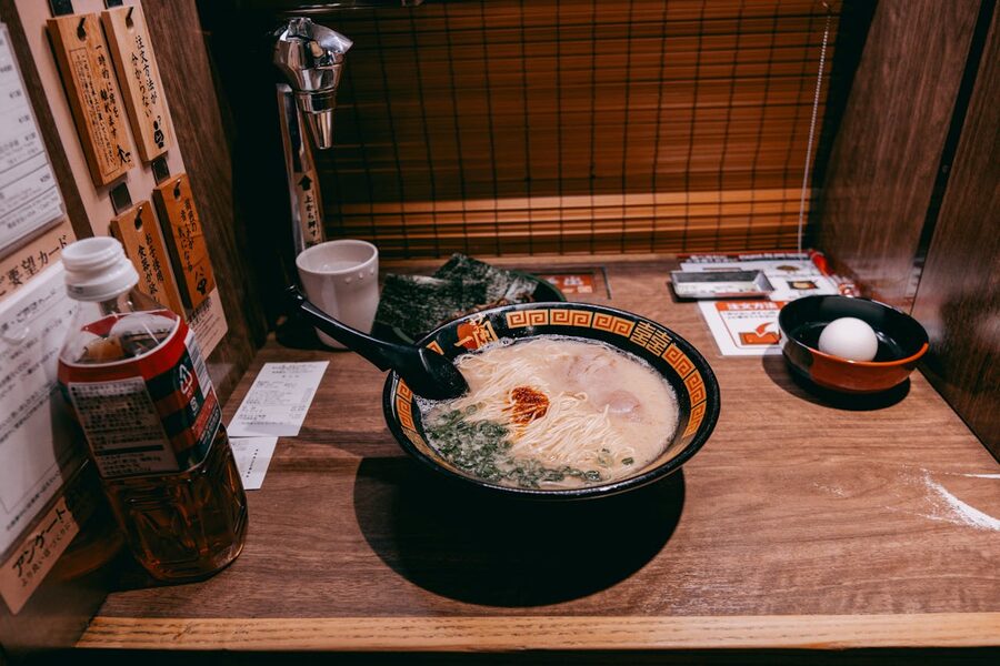 Steaming bowl of ramen served in a private dining booth in Tokyo