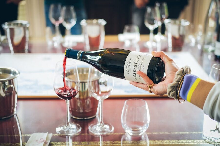 Pouring red wine into a tasting glass