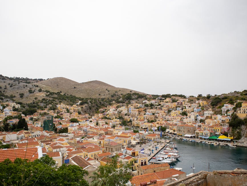 Symi harbour pastel buildings hills