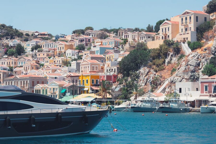 Symi waterfront boat colourful houses