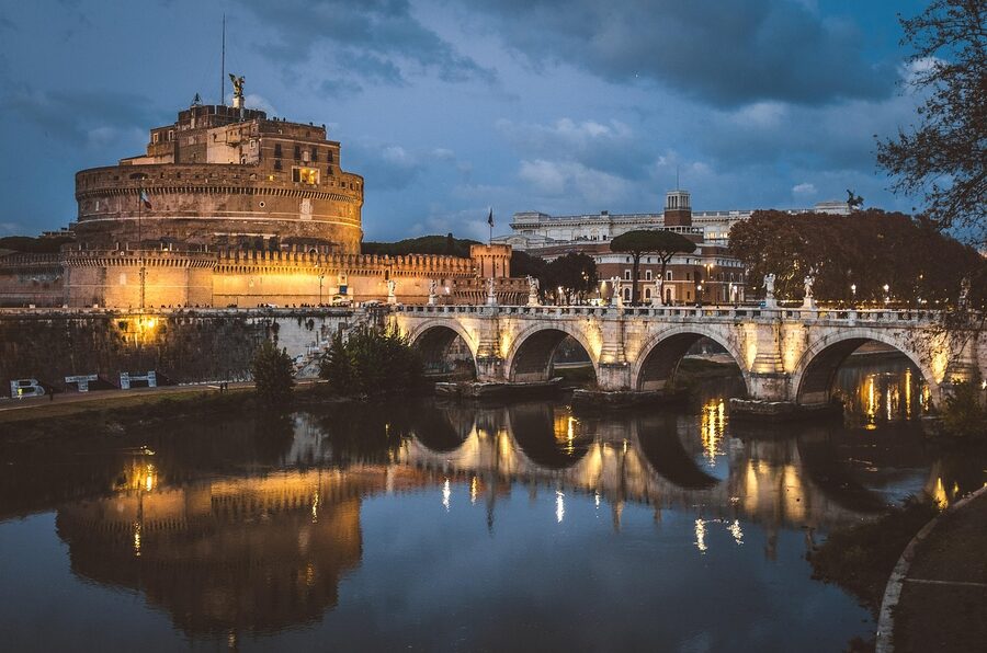 Castel Sant'Angelo lit up at dusk over the Tiber