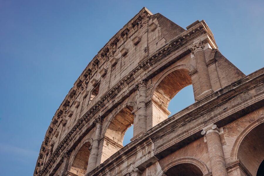 Colosseum exterior under a clear blue sky in Rome