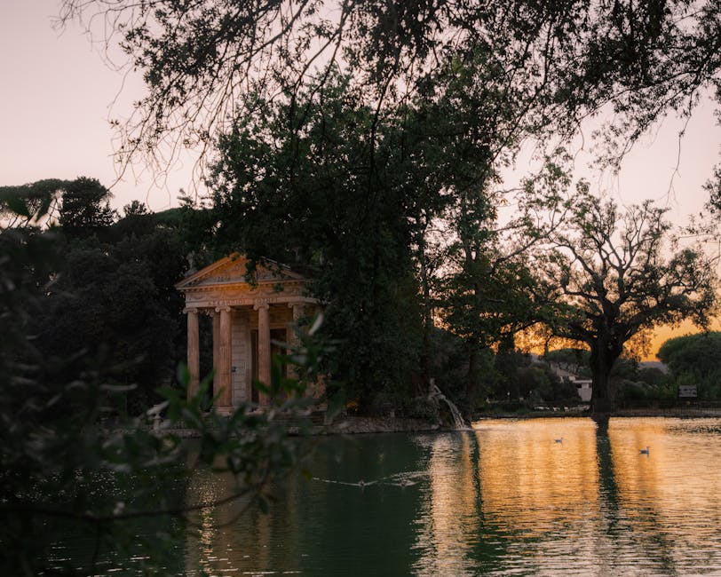 Temple of Aesculapius reflecting in pond Villa Borghese