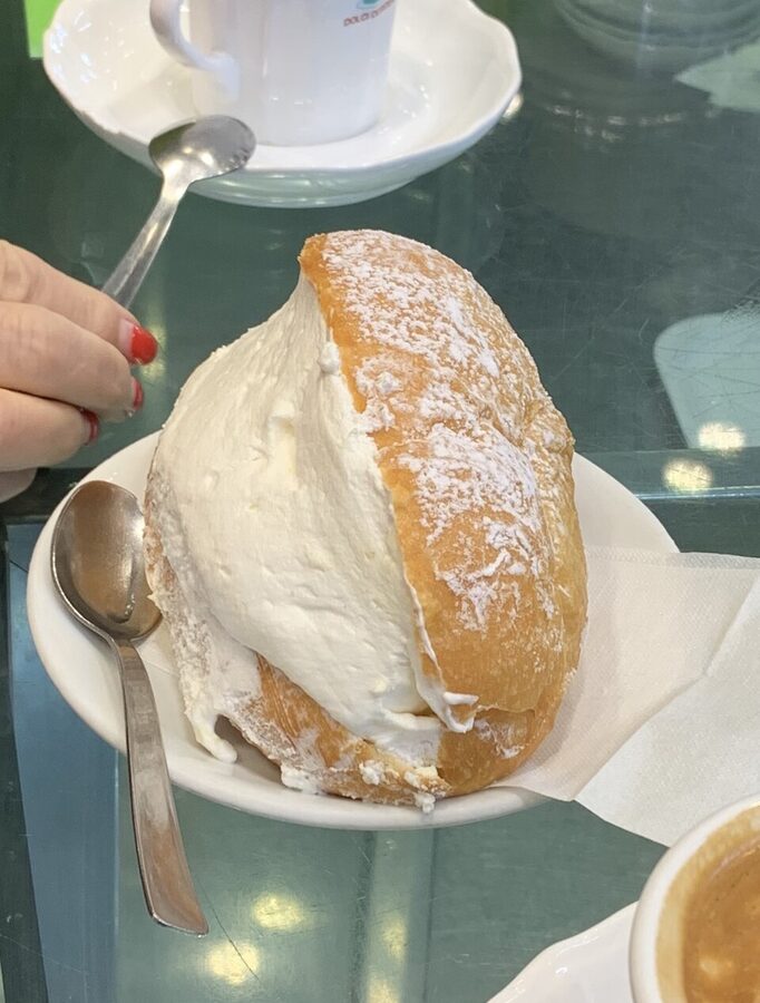Freshly baked Roman maritozzo with cream filling