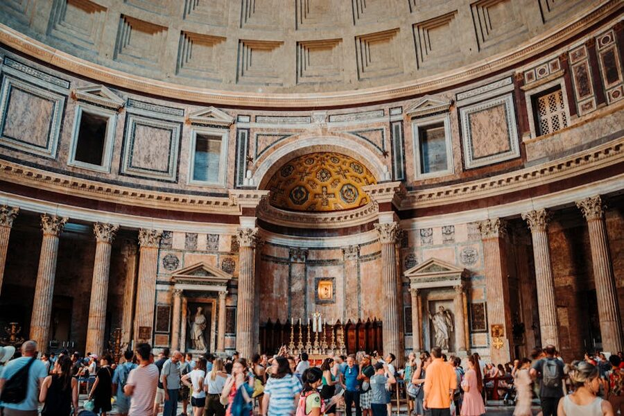 Tourists inside the Pantheon Rome looking up at the dome