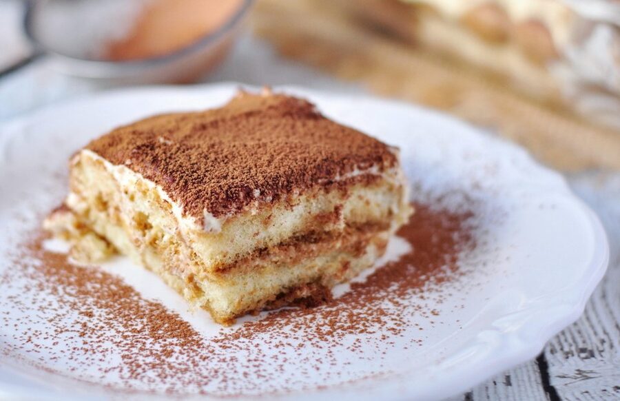 Classic Italian tiramisu plated on a white dish