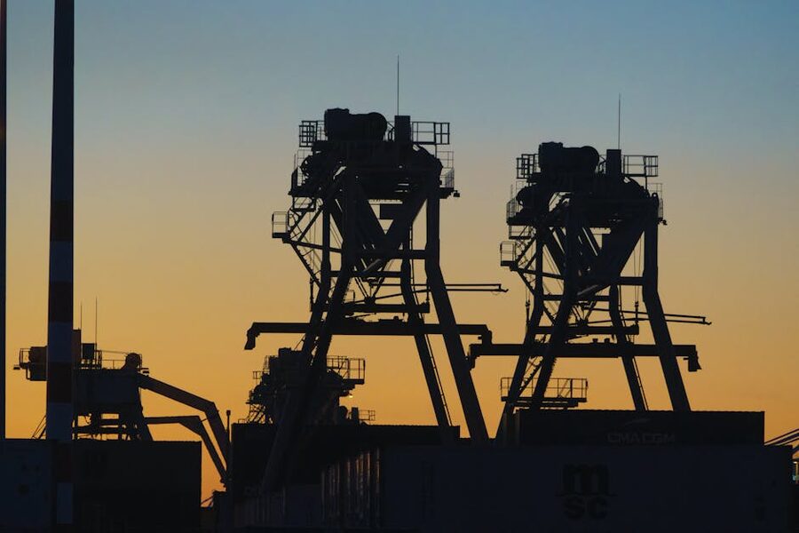 Harbour cranes at Rotterdam against sunset