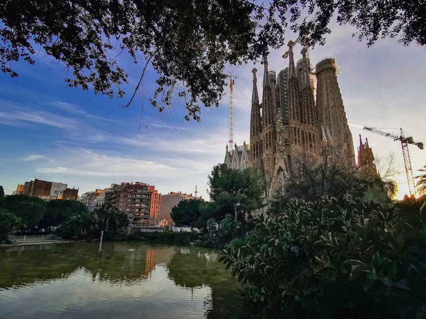 Sagrada Familia at sunset reflected in pond
