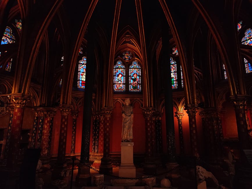Sainte-Chapelle interior with statue and Gothic stained glass windows