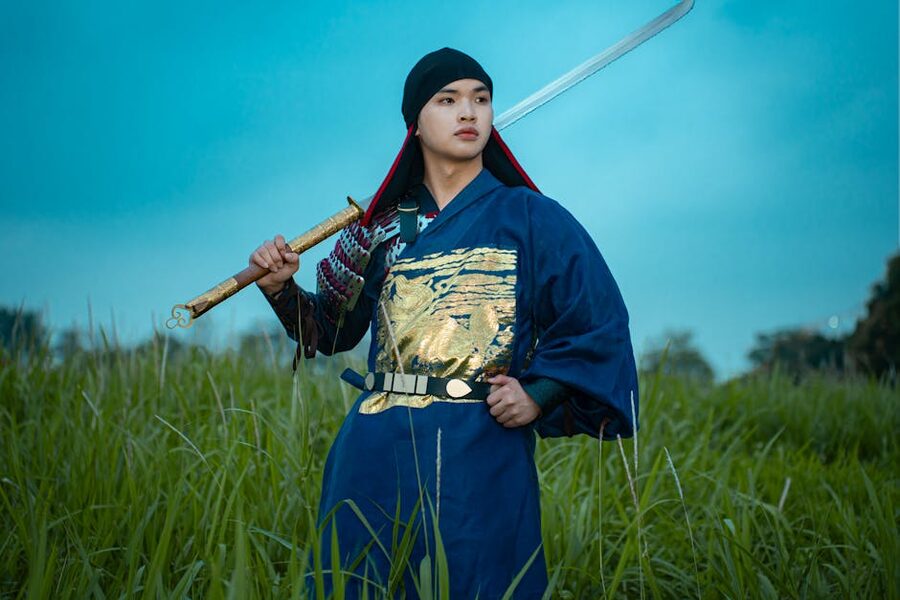 Samurai in traditional attire holding a sword at dusk