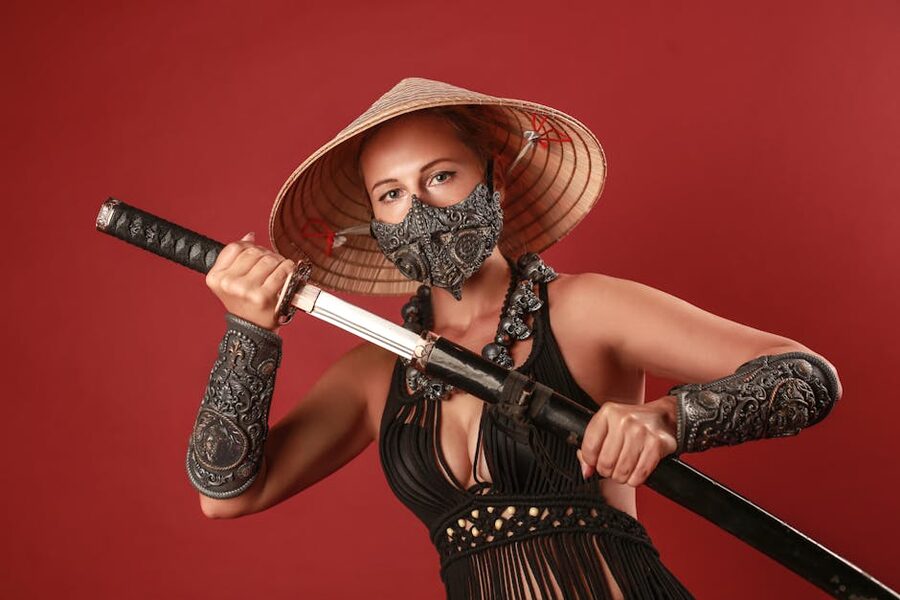 Samurai with katana on red backdrop during a Tokyo dinner show