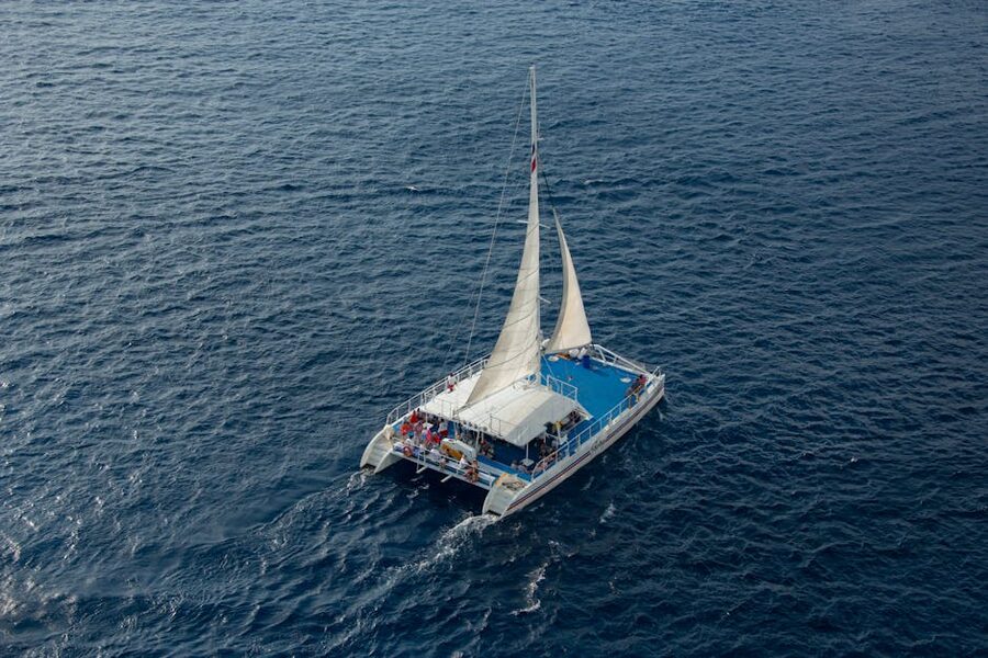 Aerial shot catamaran sailing passengers Santorini caldera