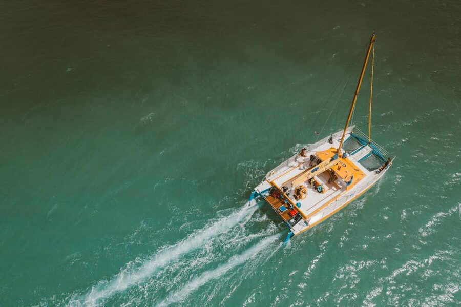 Yacht aerial sailing turquoise sea passengers Santorini