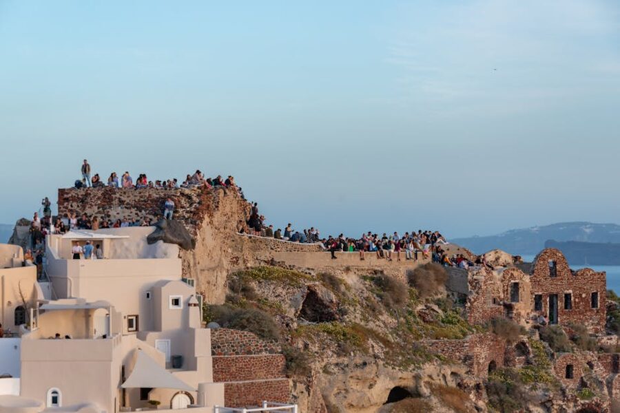 Oia sunset crowd Santorini cliff