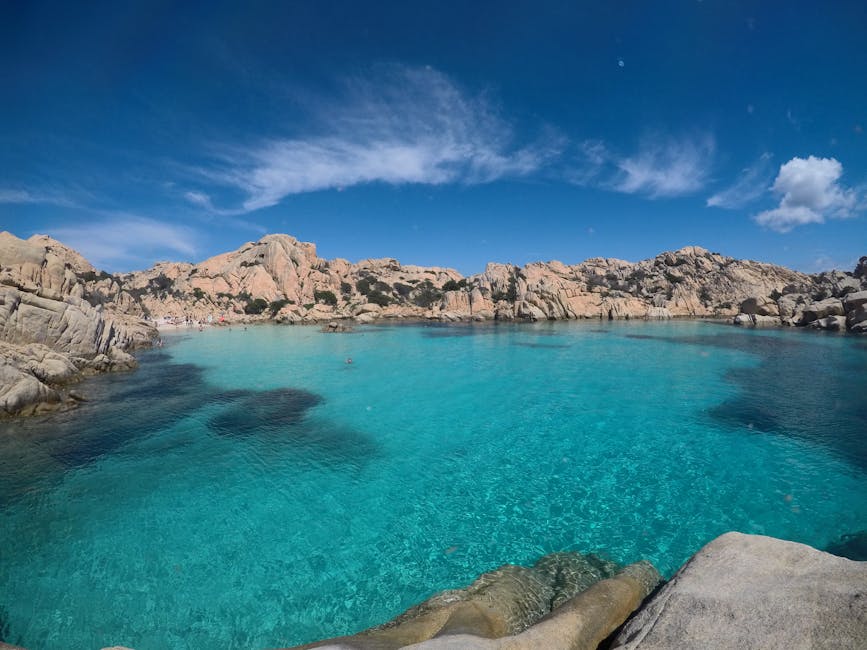 Rocky granite shoreline and bright blue water of La Maddalena island