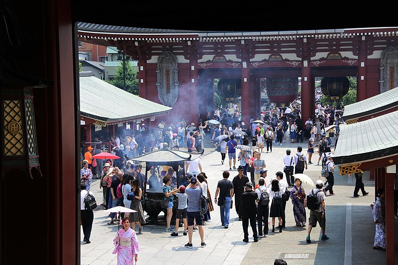 Visitors surrounded by incense smoke at Sensoji Temple Tokyo