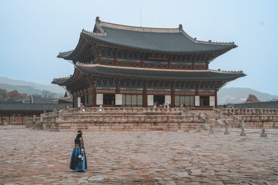 Woman in hanbok walking at Gyeongbokgung Palace in Seoul