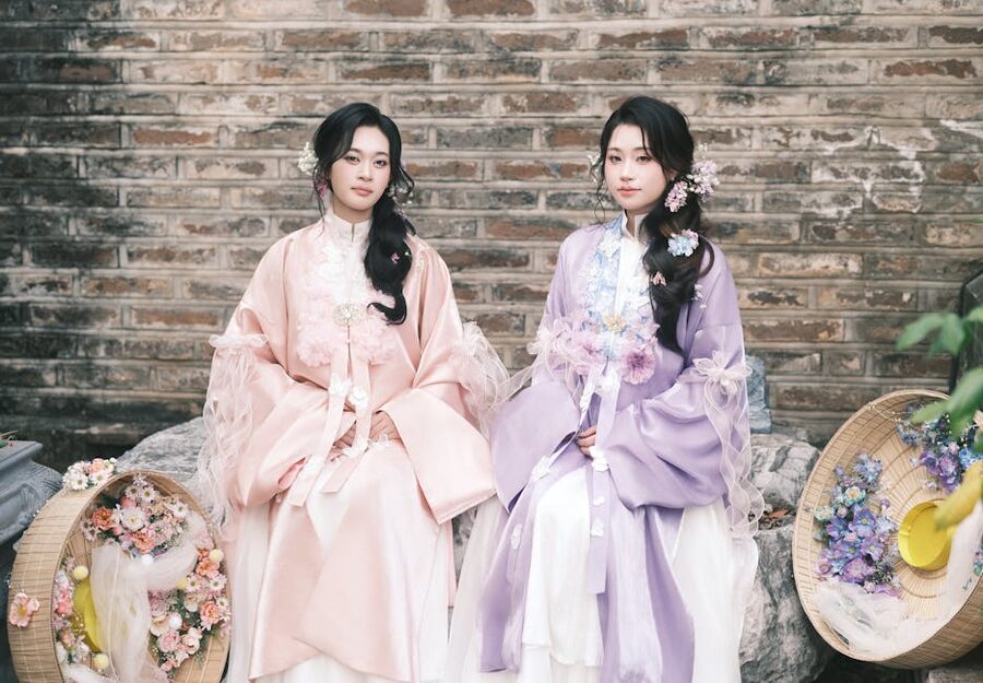 Two women in hanbok with floral accessories