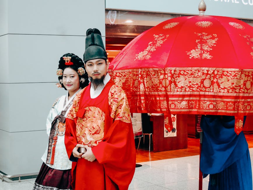 Couple in royal hanbok with red parasol