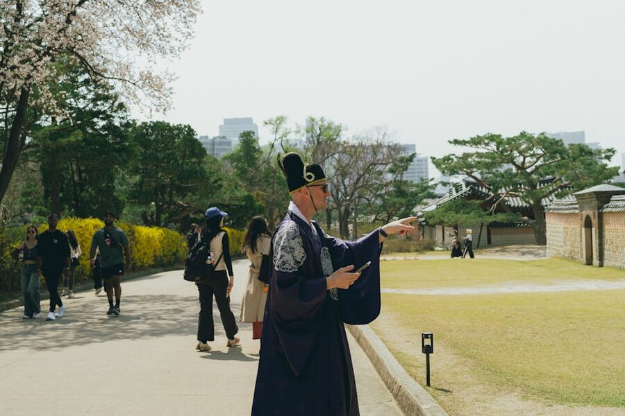 Man wearing traditional hanbok with cherry blossoms in Seoul park
