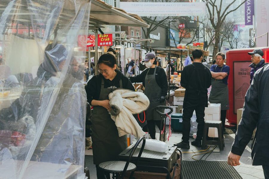 Myeongdong street market with food stalls and shoppers in Seoul