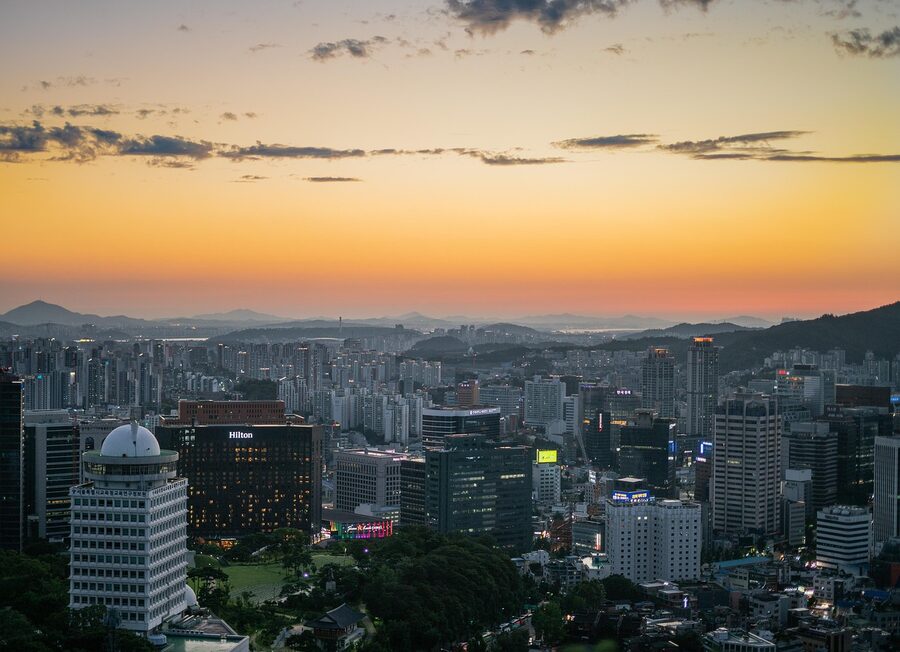 Myeongdong Seoul with neon signs and street crowds at sunset
