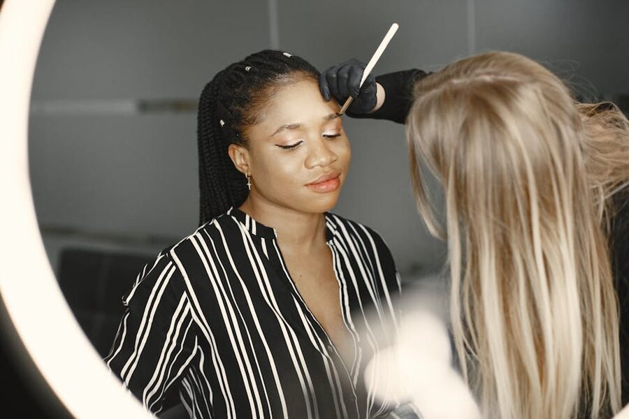 Makeup artist applying cosmetics during a color analysis session in Seoul