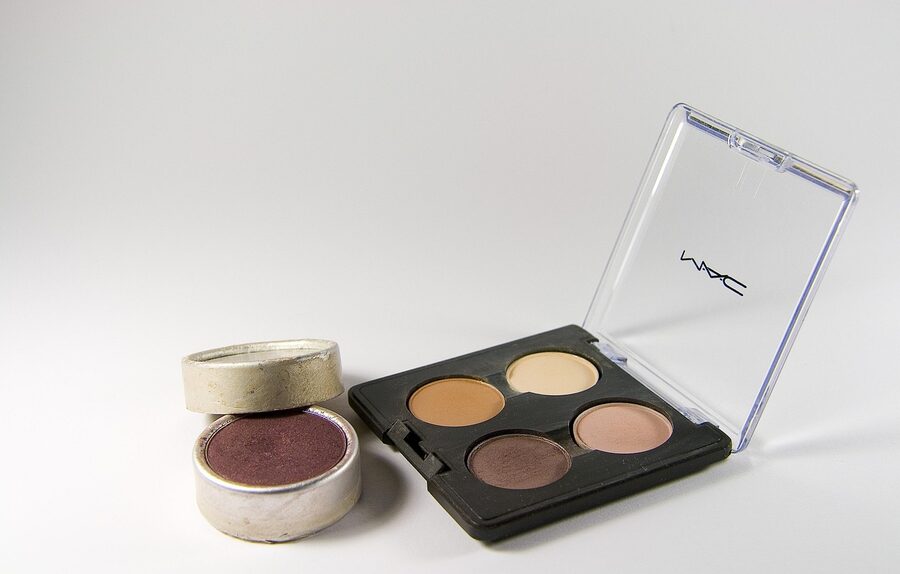 Eyeshadow palette and makeup products laid out for a color analysis client