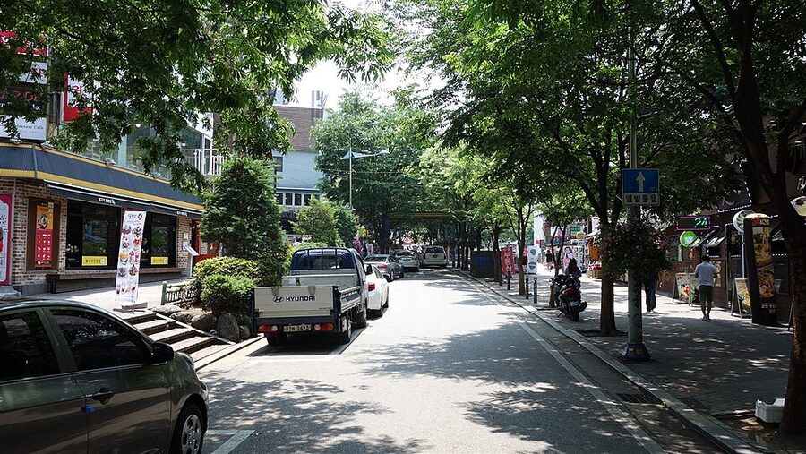 Main sidewalk in Hongdae district Seoul with shops and restaurants