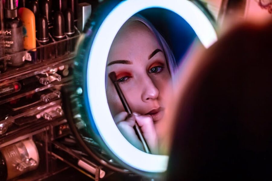 Woman under ring-lit studio mirror during a Seoul makeup session
