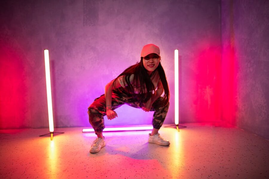 Solo dancer practising in a neon-lit studio