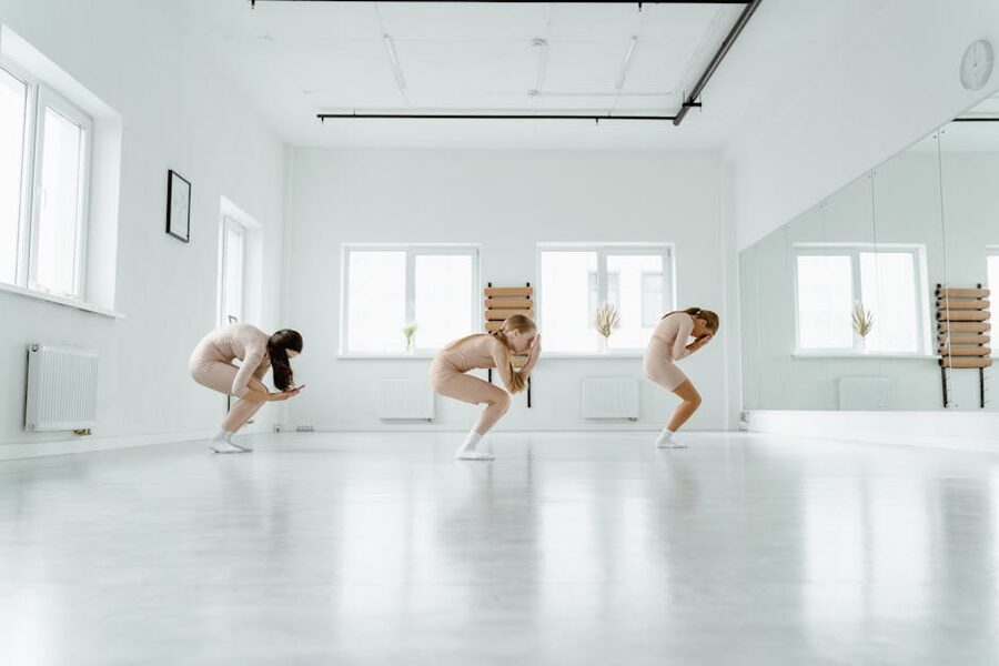 Three dancers rehearsing in a bright Seoul studio