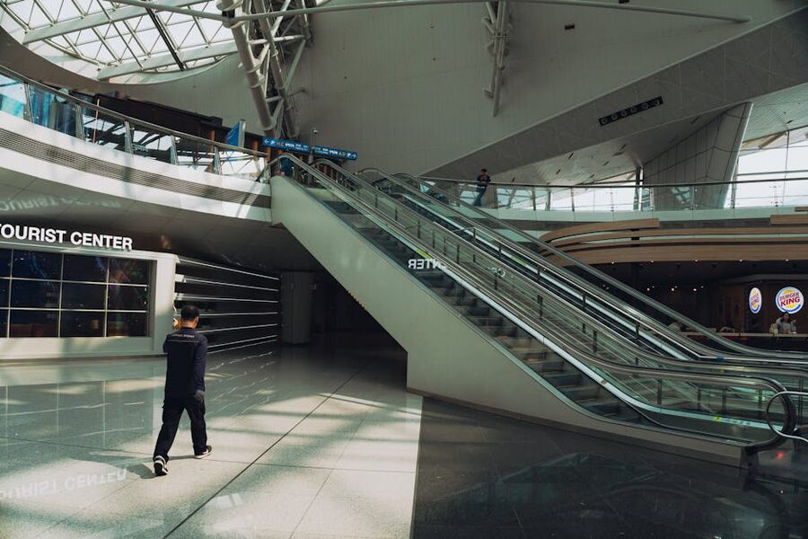 Incheon Airport terminal interior with travelers on escalators